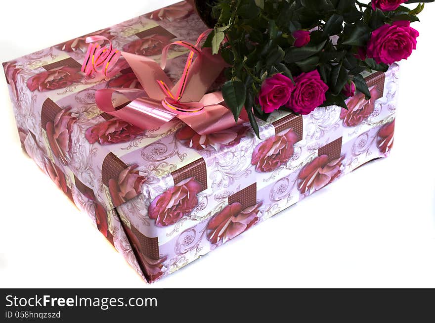 Box with a gift and bouquet of roses on a white background