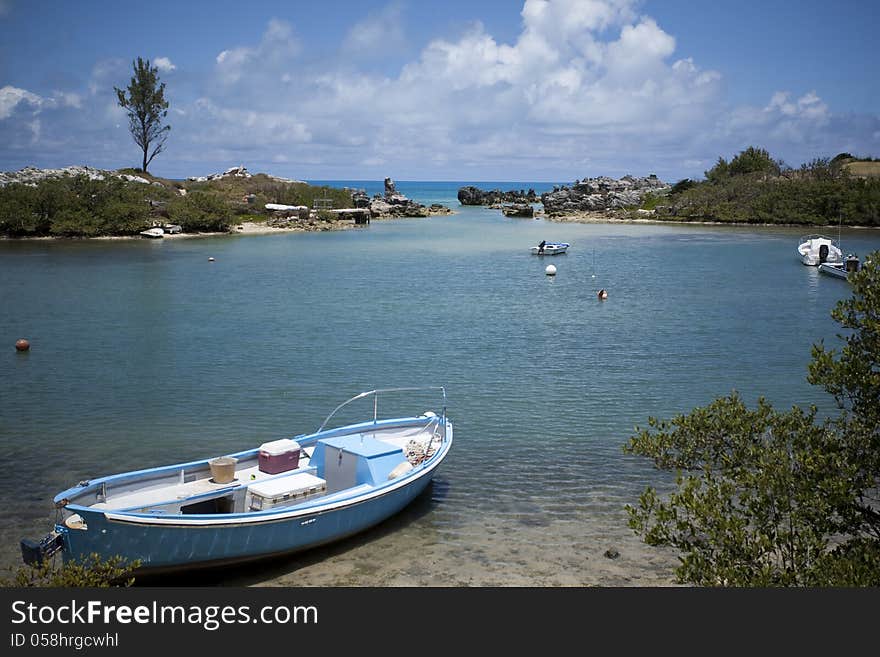 Small Boat In Cove By The Ocean