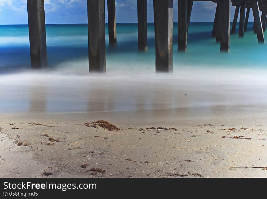 Long exposure image of the Atlantic Ocean taken below the fishing pier at Dania Beach in Florida. Long exposure image of the Atlantic Ocean taken below the fishing pier at Dania Beach in Florida.