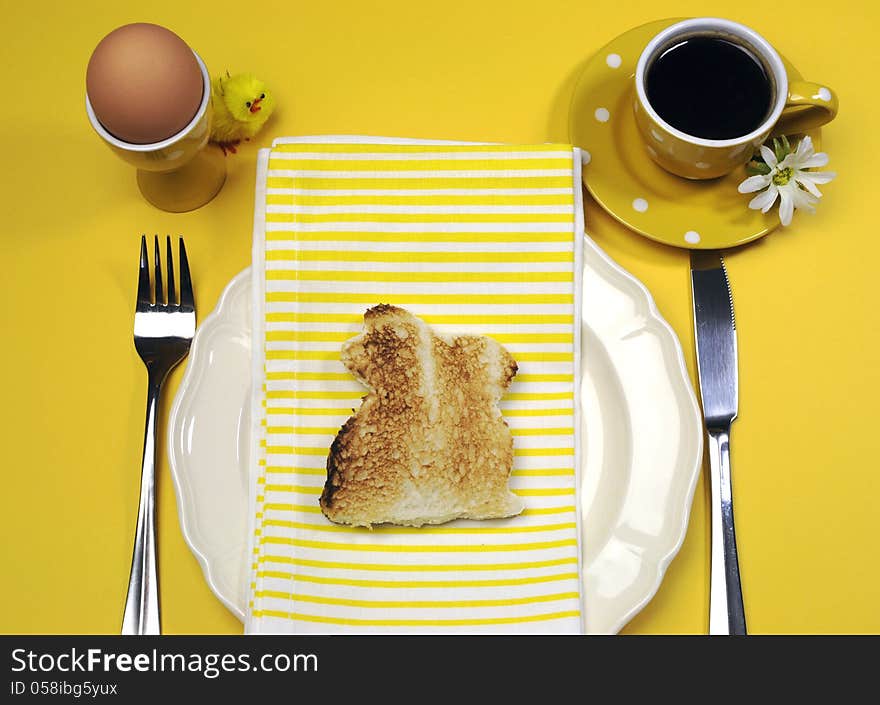 Yellow theme Happy Easter breakfast table with bunny rabbit toast and egg.