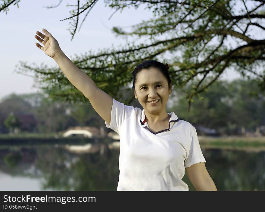 Happy woman smiling carefree and joyful in beautiful park. Happy woman smiling carefree and joyful in beautiful park.