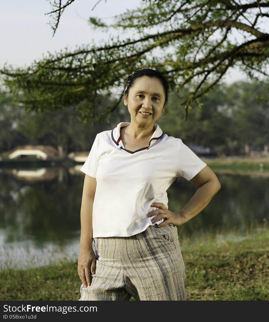 Happy woman posing against a nature