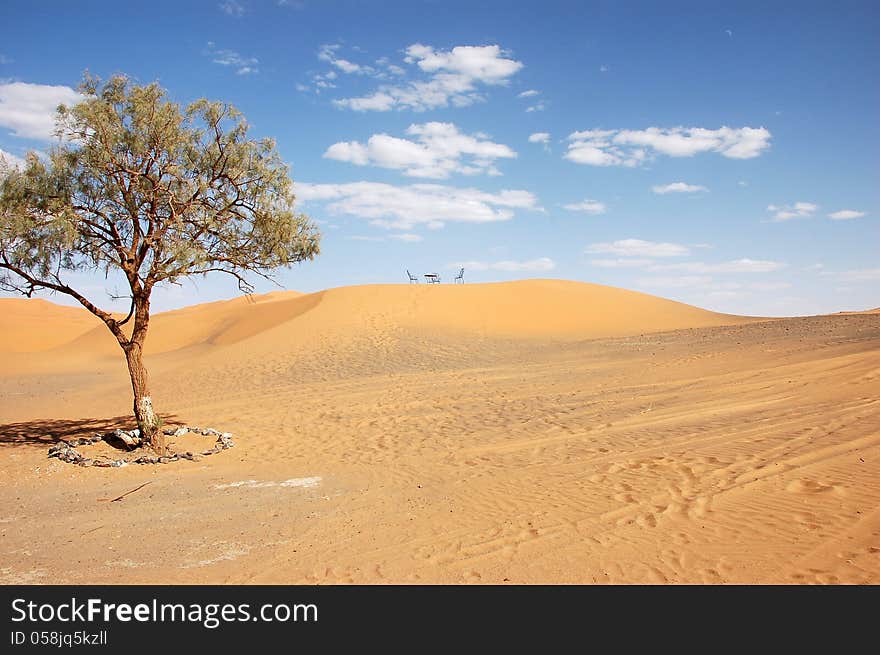 Wrought Iron Table And Chairs On The Top Of Sand Dune