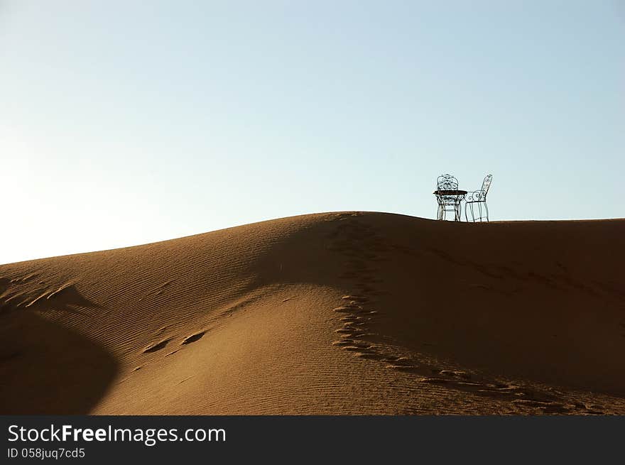 Wrought iron table and chairs on the top of sand dune