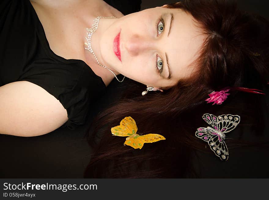 Portrait of European woman with butterflies on the hair