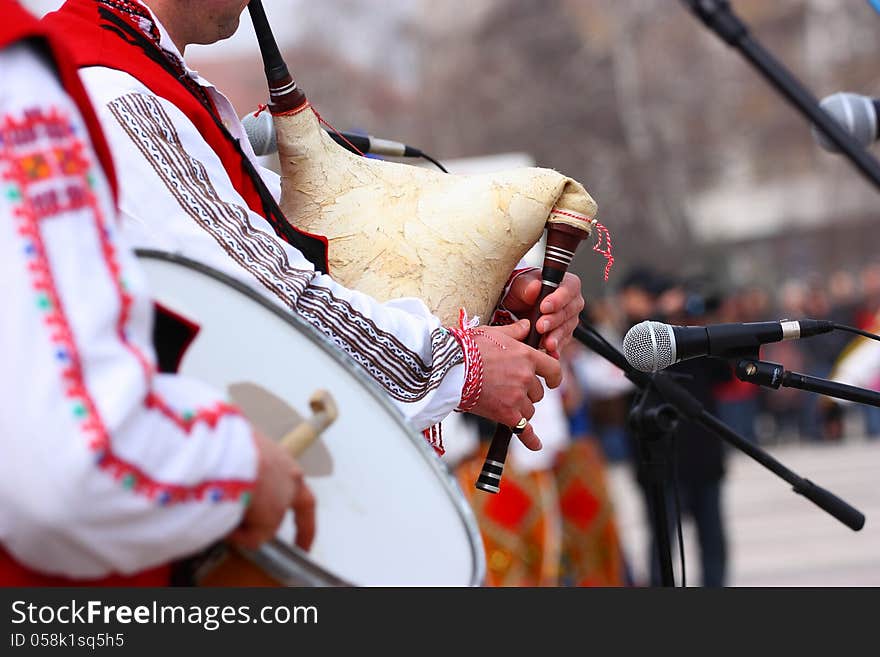 Folklore musicians playing on bagpipe and drum outdoor