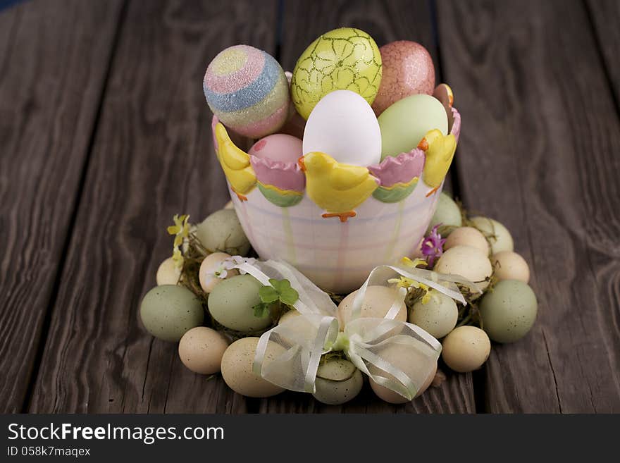 Easter eggs in a bowl and on a wooden table. Easter eggs in a bowl and on a wooden table.