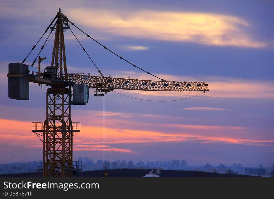 Building crane on sky background at sunset. Building crane on sky background at sunset.