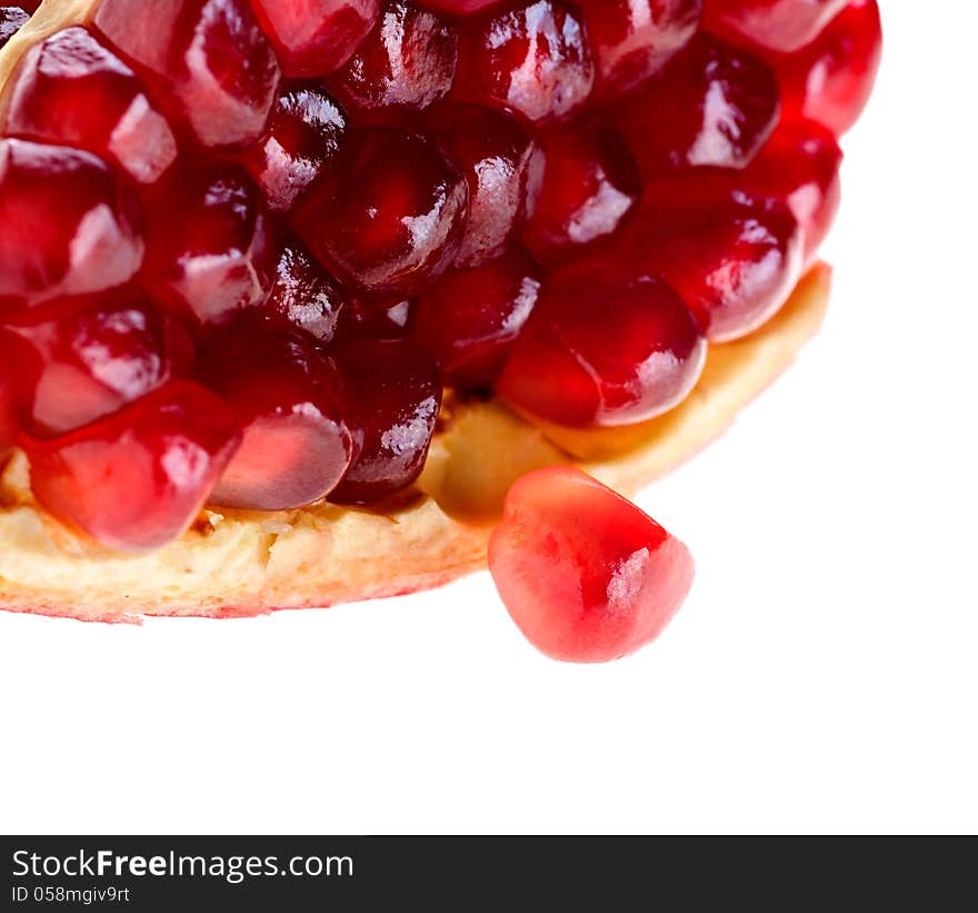 Seed of pomegranate fruit has dropped out of the group on a white