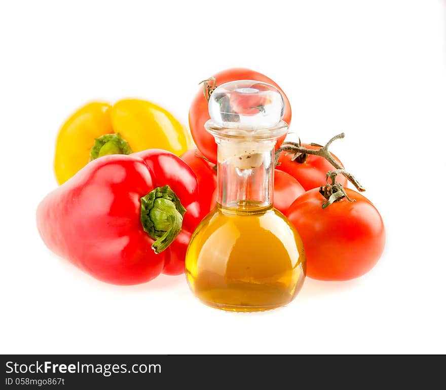 Bottle with olive oil ,tomatoes and peppers on a white background