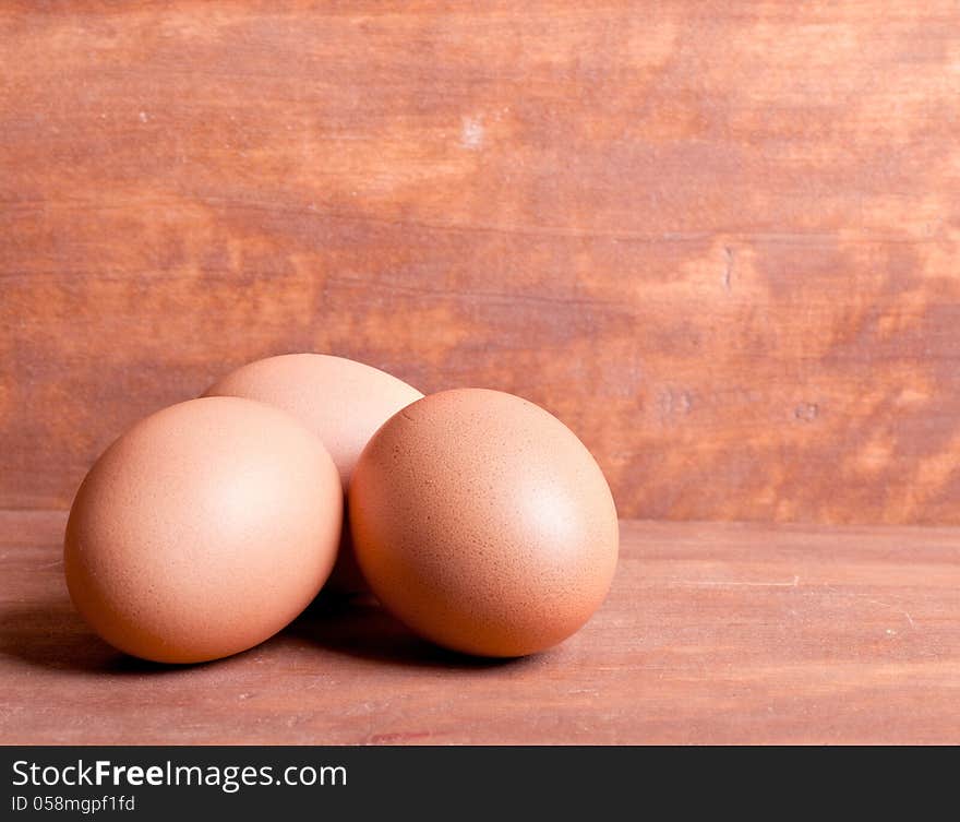 Three yellow balls on the wooden background