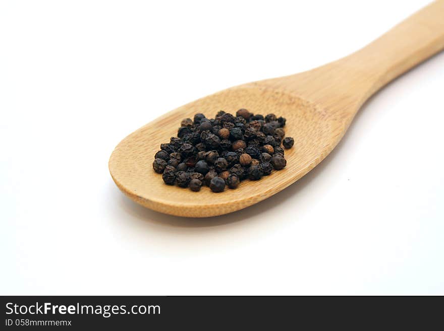 Pepper in wooden spoon