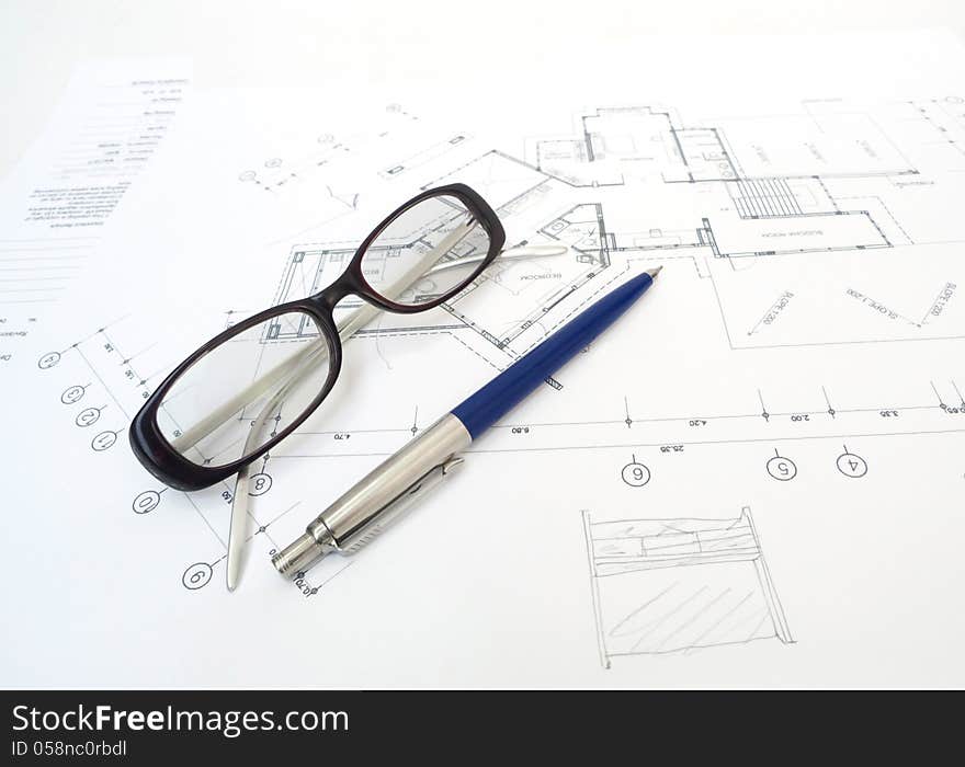 Glasses And A Pencil With Architectâ€™s Plans.