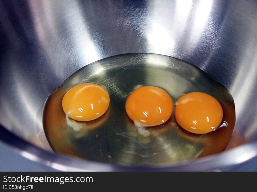 Three Egg Yolk in stainless Container.