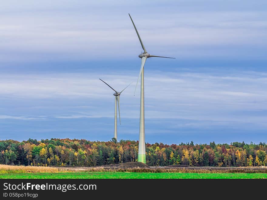 Wind turbine in a field in the evening, producing wind, Canada