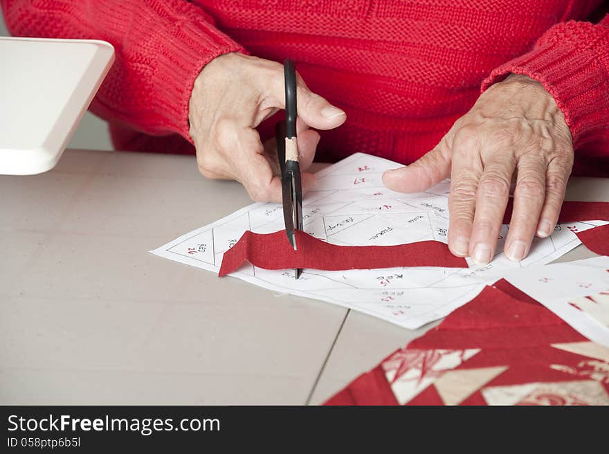 Quilter Cuts Fabric To Fit Pattern