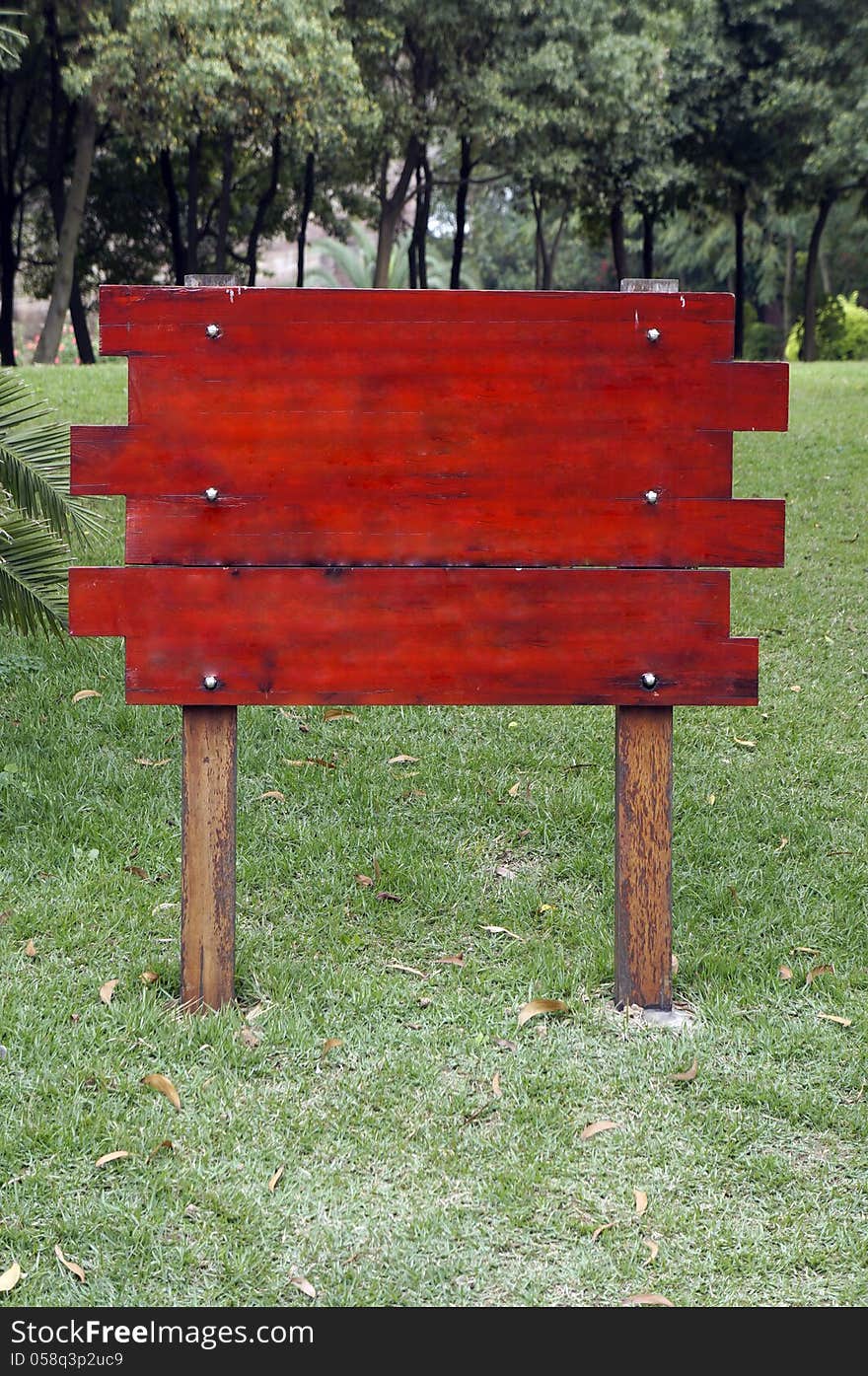 Blank wooden sign in grassland