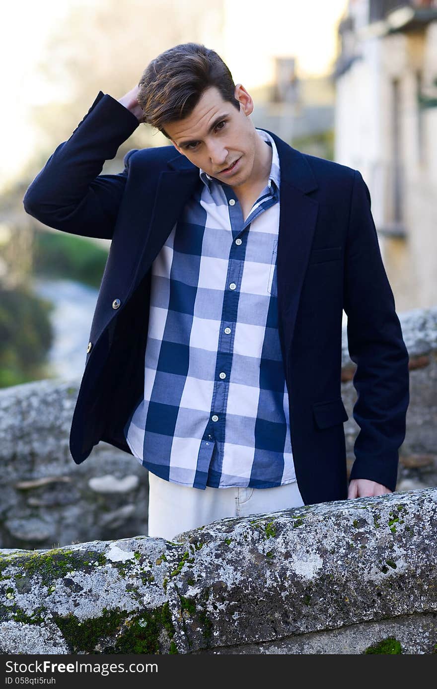 Handsome Man With Modern Hairstyle Smiling In Urban Background