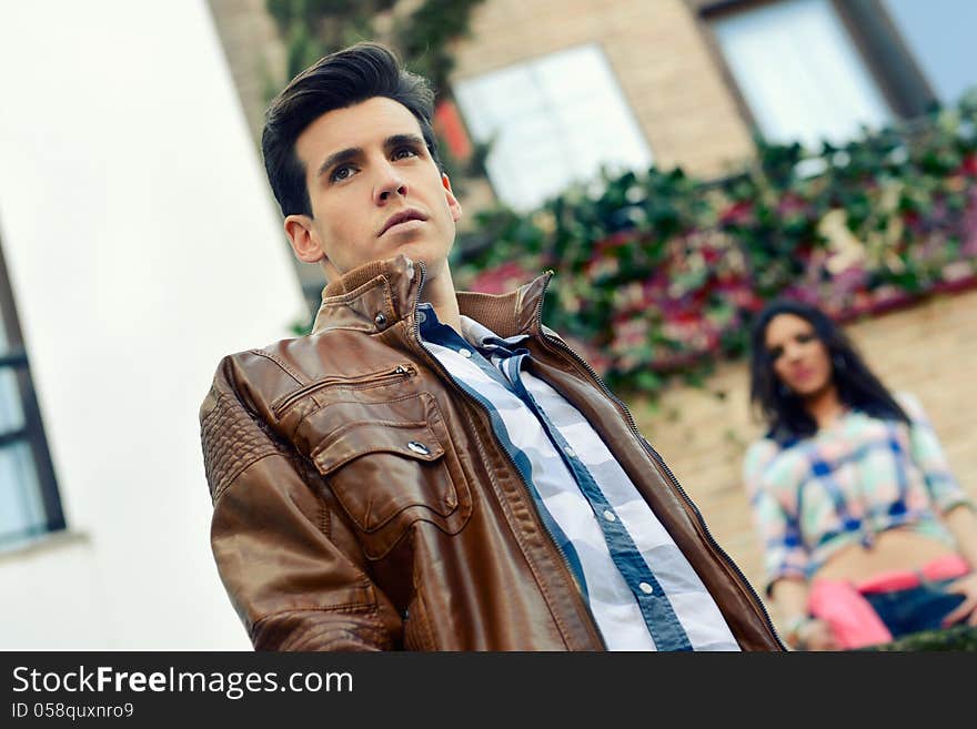 Handsome man with modern hairstyle in urban background