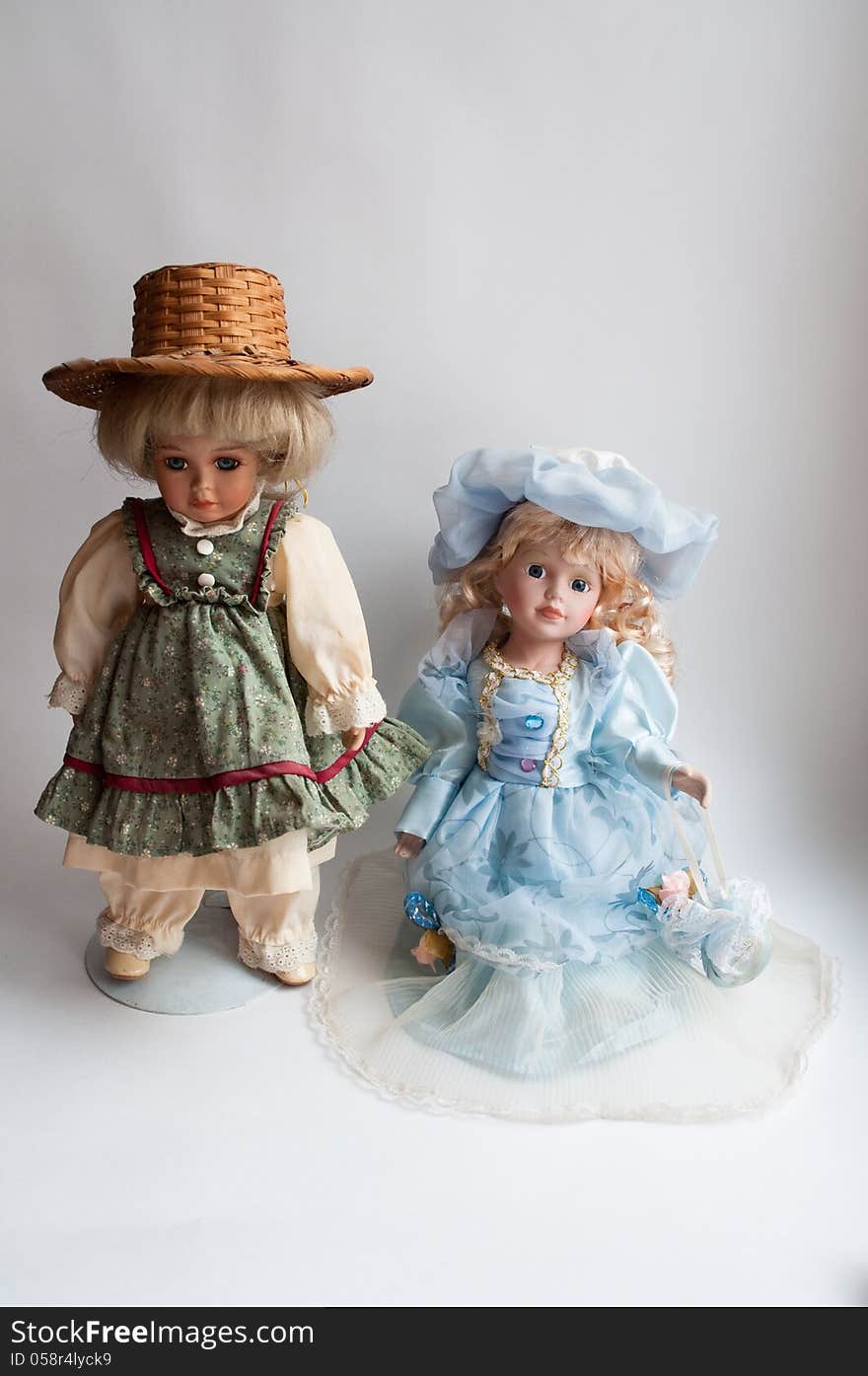 Photo the doll on a light background . Pretty doll in the antique dress