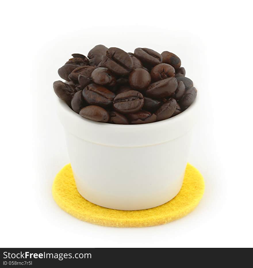 Cup of Coffee beans on white background