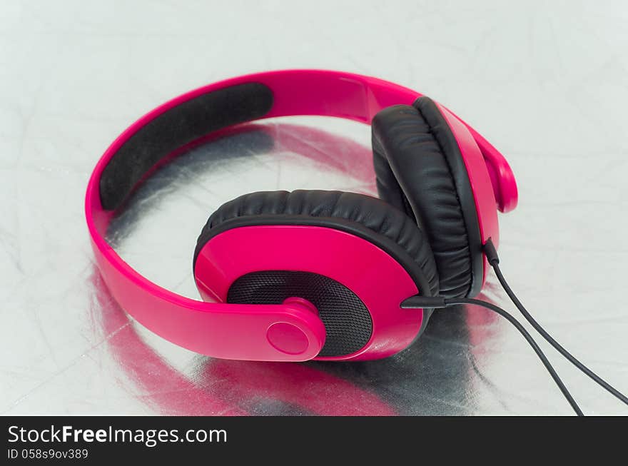 Pink headphone put on the floor.