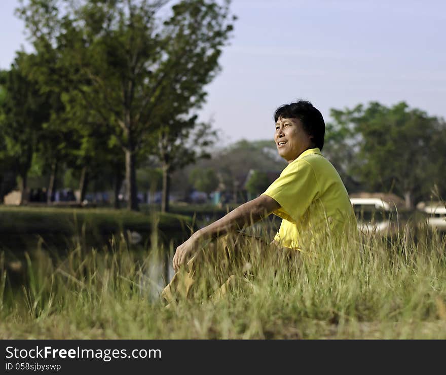 A portrait of a happy South Asian man by lake