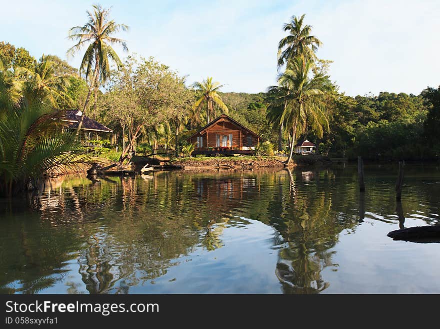 Wooden cottage on the waterfront of the tropical jungle. Wooden cottage on the waterfront of the tropical jungle