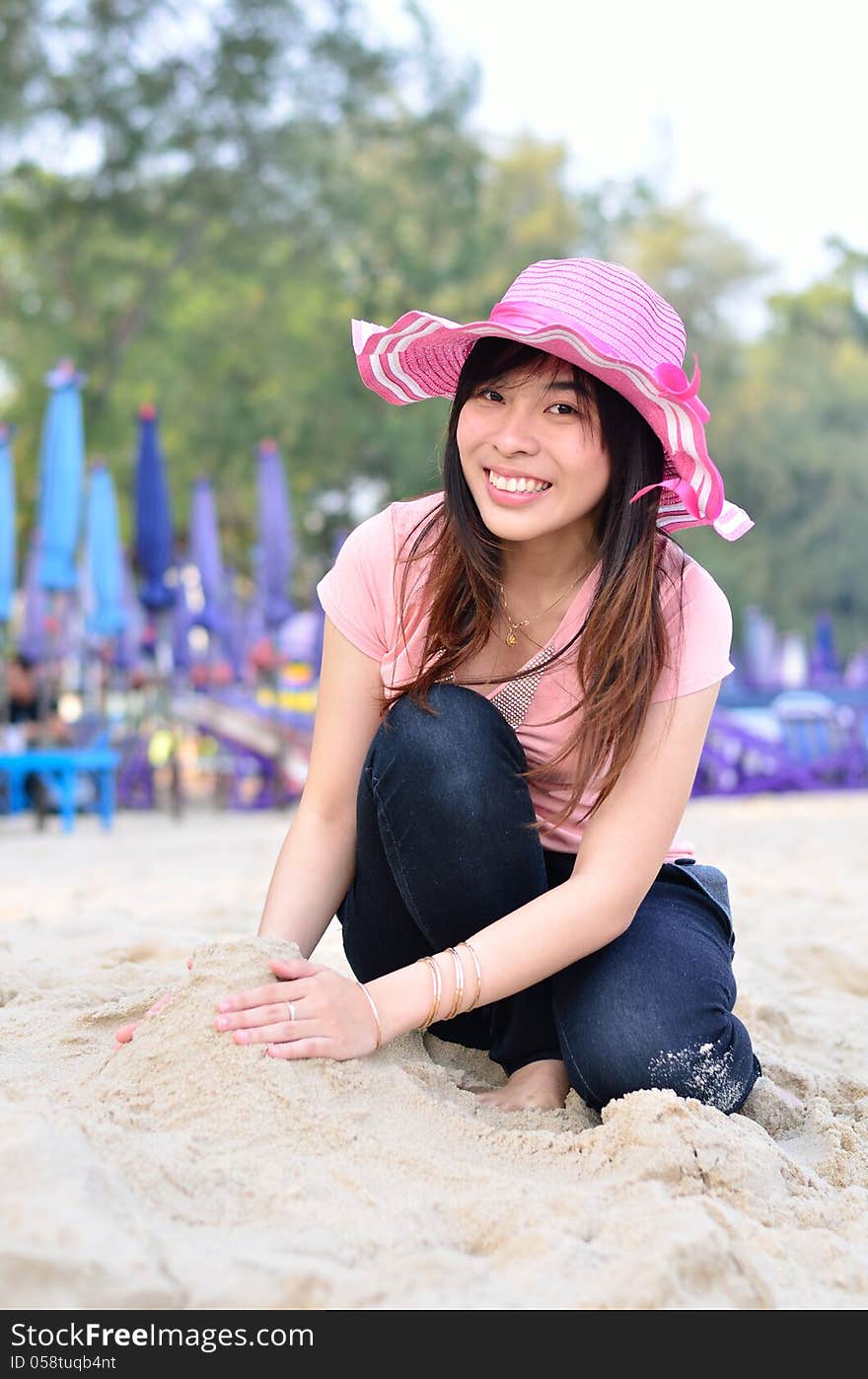 Beautiful asian woman relaxation on beach with hat