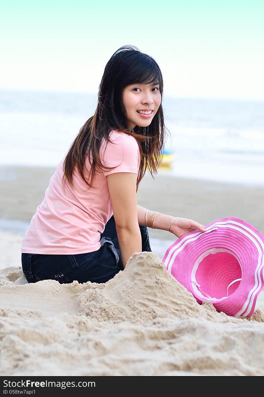 asian woman relaxation on beach with hat