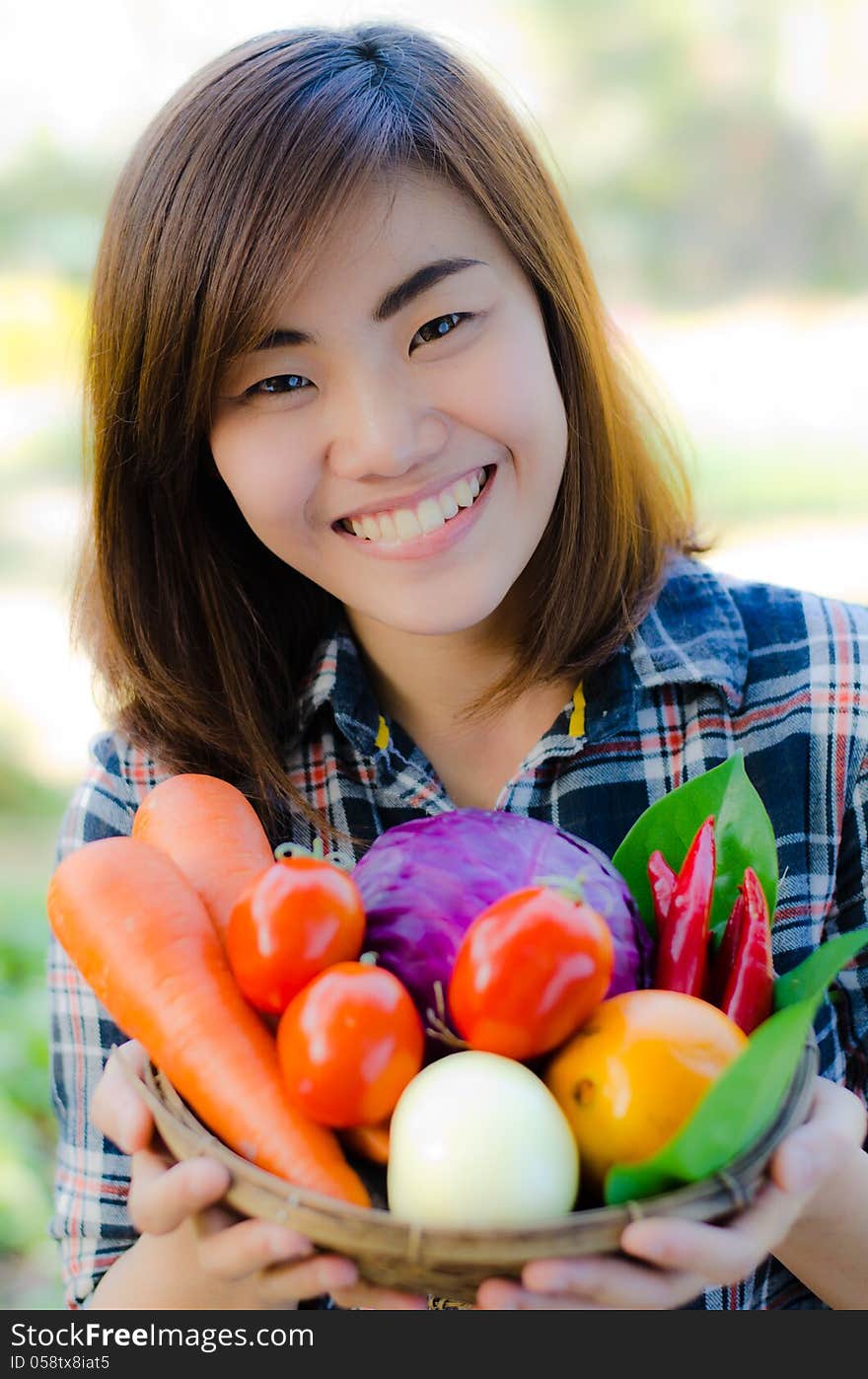 Close up Beautifull asian woman holding fresh vegetable bucket