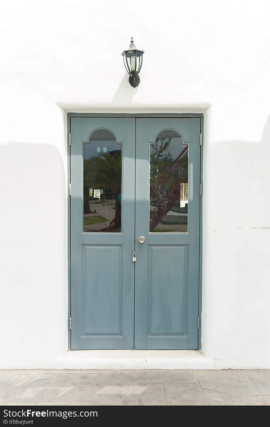 Grey old door and white concrete wall. Grey old door and white concrete wall