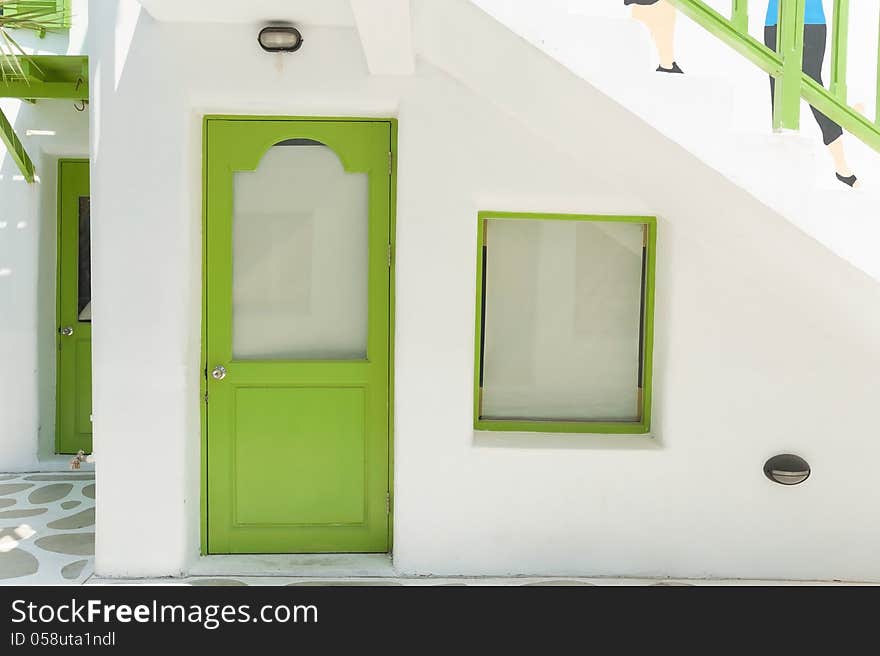 Old green door and white concrete wall