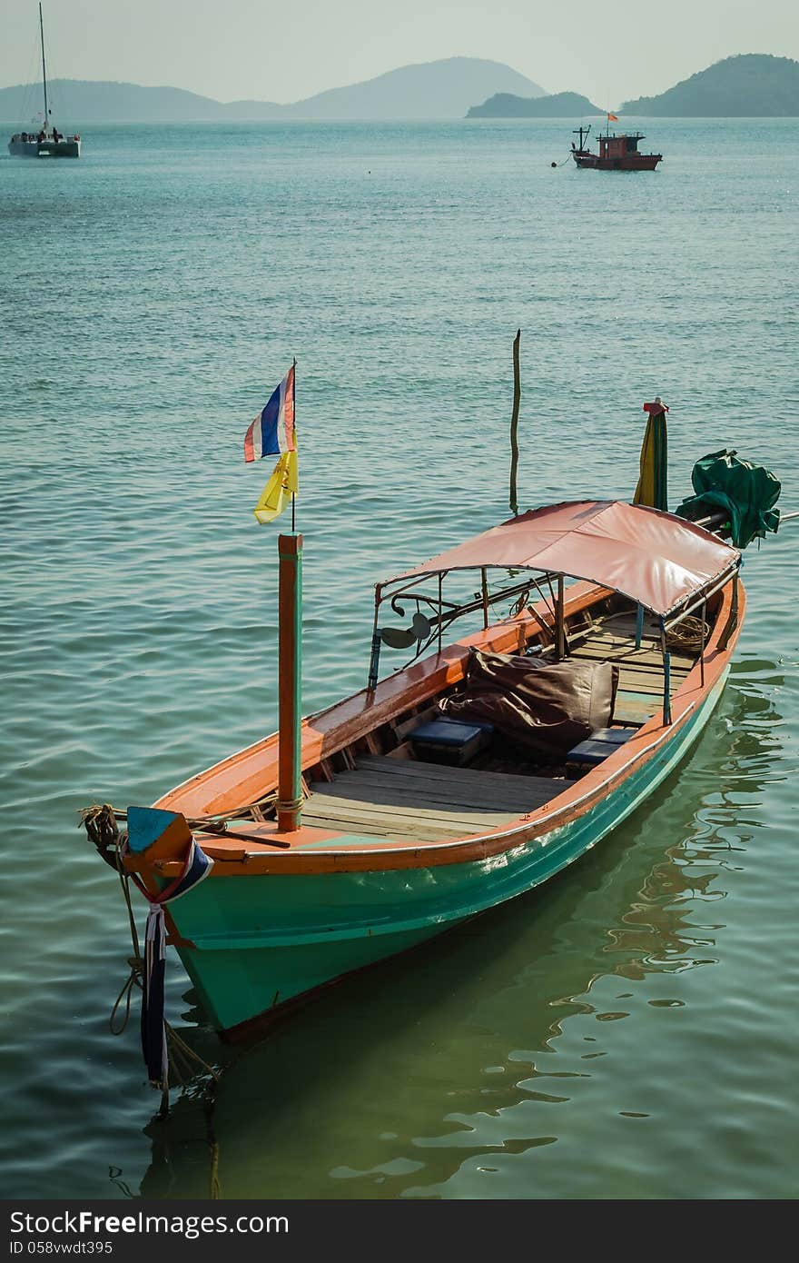 A green long tail boat at panwa cape, phuket