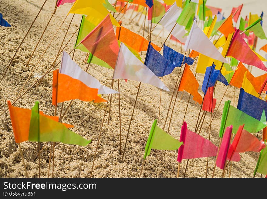 Many of paper flag put in a heap of sand to celebrate a temple. Many of paper flag put in a heap of sand to celebrate a temple