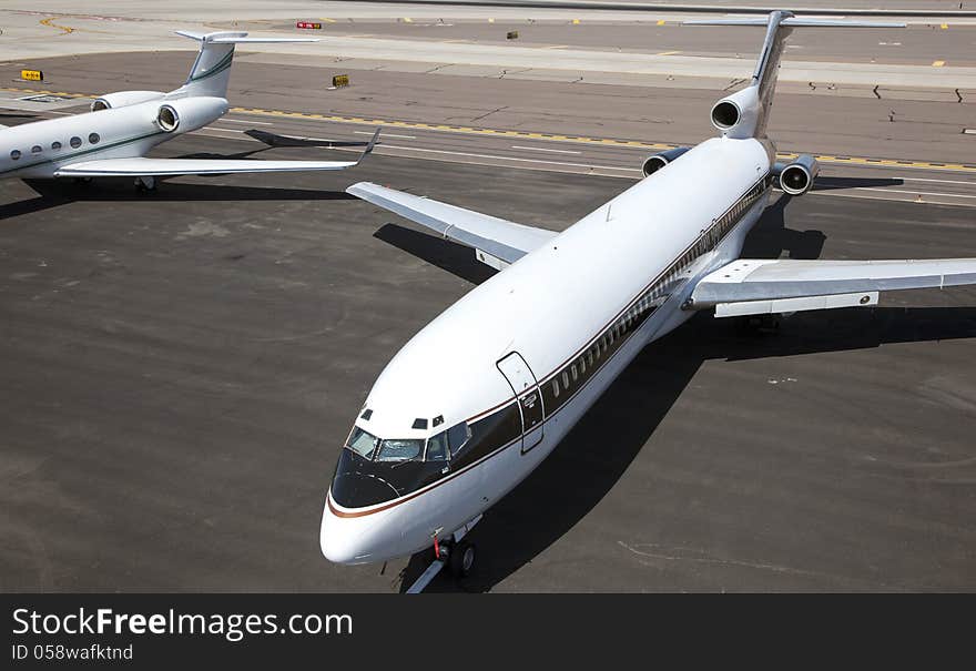 Jet aircraft parked on tarmac at airport. Jet aircraft parked on tarmac at airport