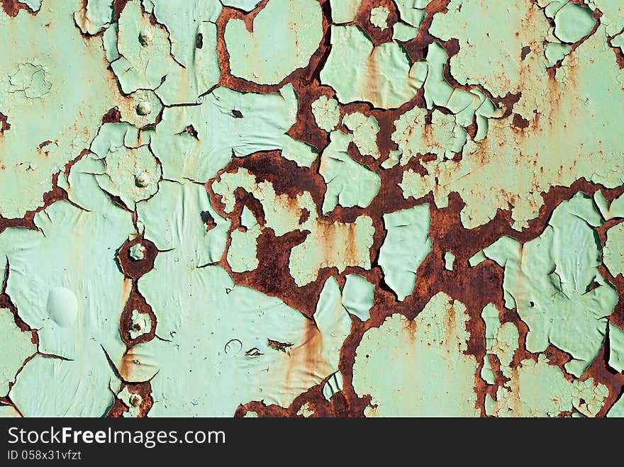 Peeling paint on a rusted metal surface. Peeling paint on a rusted metal surface