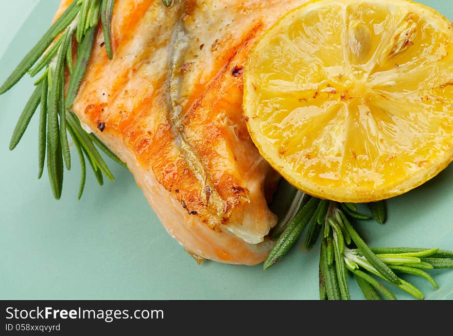 Fillet of Grilled Salmon with Rosemary and Lemon closeup on Green Plate