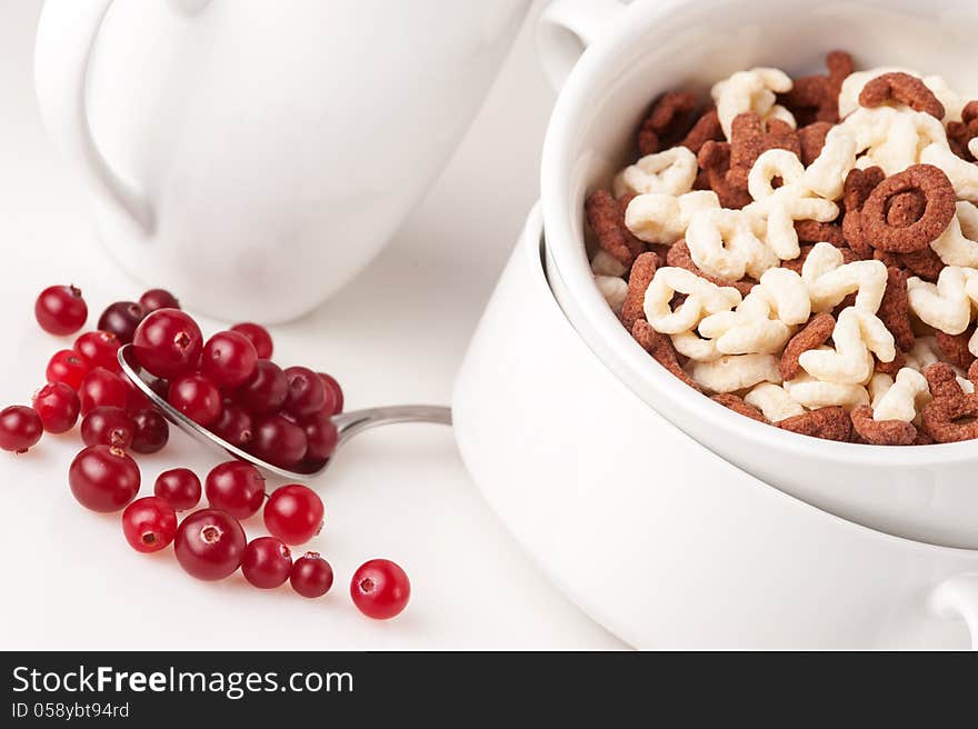 Alphabet cereal in the white bowl with ripe сranberries. Alphabet cereal in the white bowl with ripe сranberries