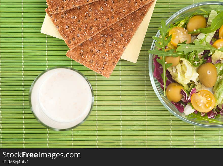 Vegetable salad with diet biscuits and glass of yogurt top view. Vegetable salad with diet biscuits and glass of yogurt top view