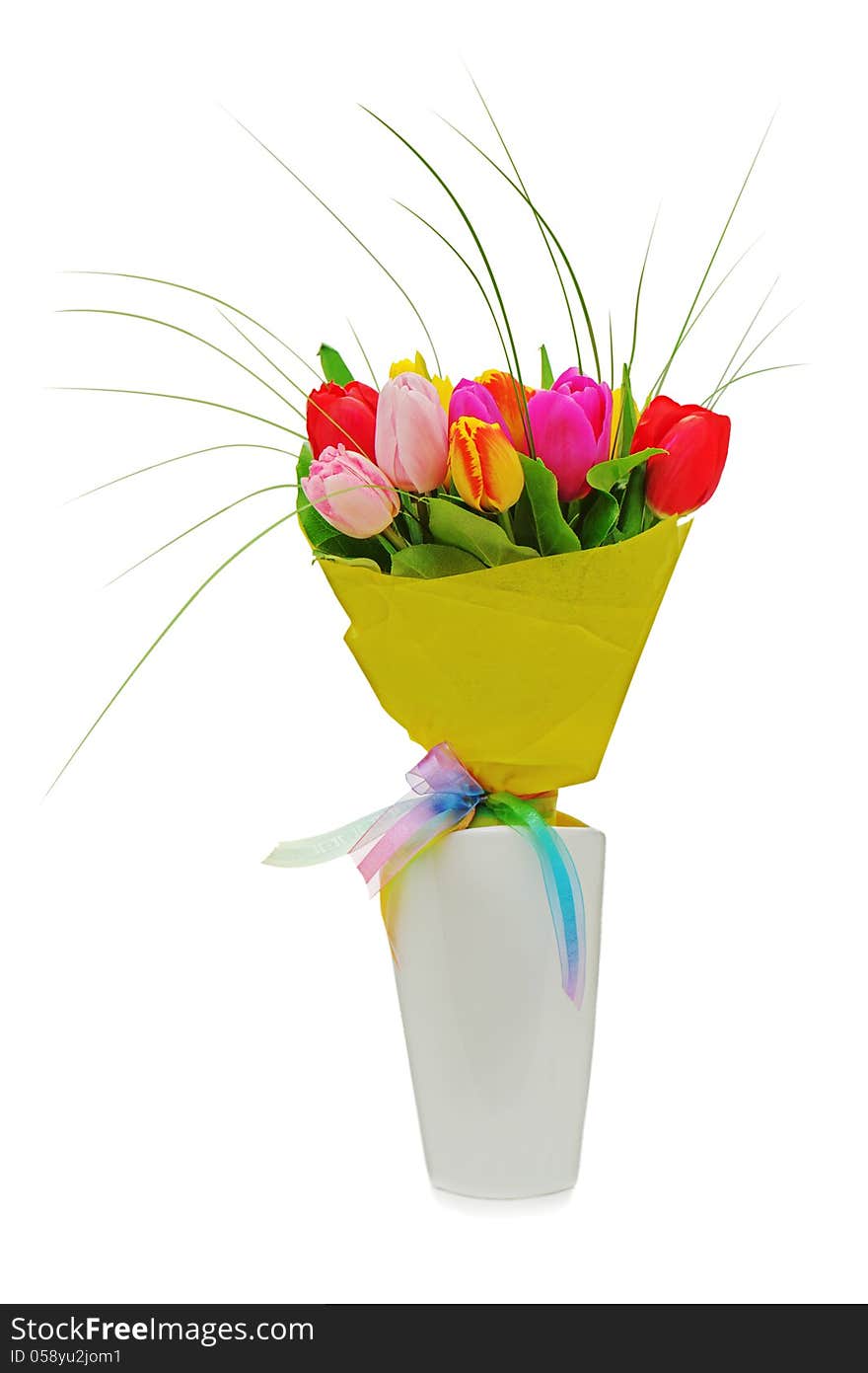 Flower bouquet from colorful tulips in white vase isolated on white background.