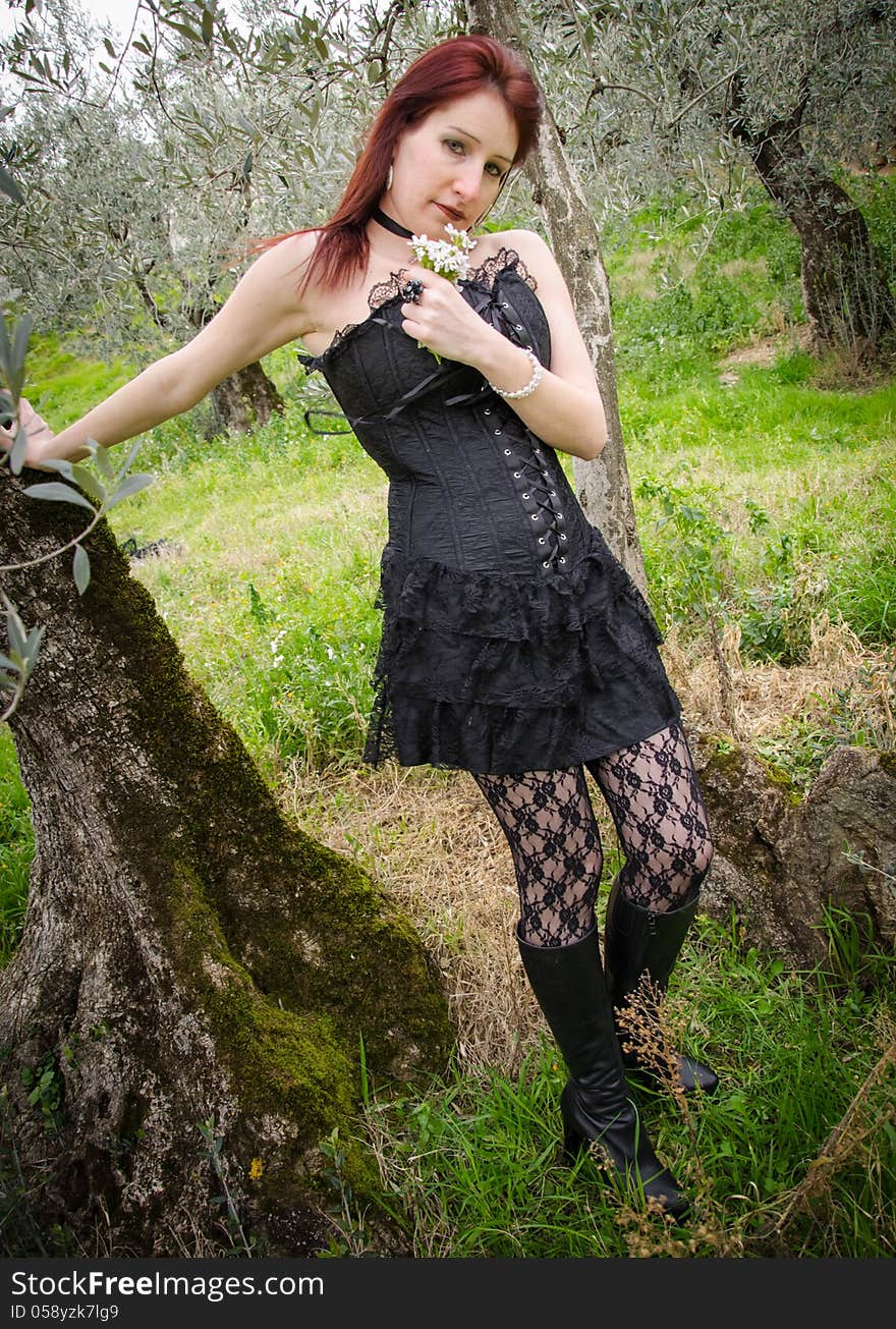 Gothic girl with flowers in the hand