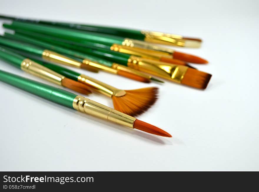 Many different type and size of paintbrushes on white background. Many different type and size of paintbrushes on white background