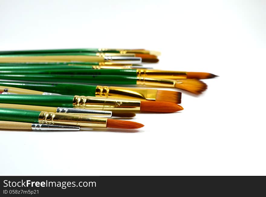 Many different type and size of paintbrushes on white background. Many different type and size of paintbrushes on white background