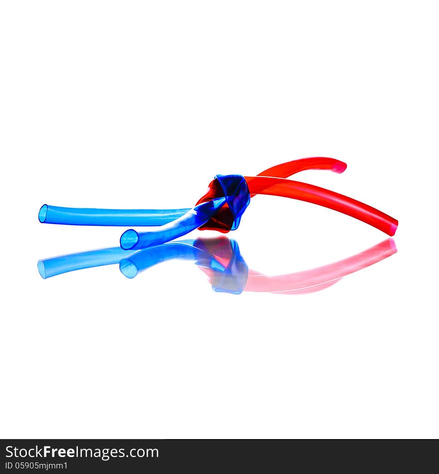 Two red and blue PVC Hoses tied together with shadow reflection