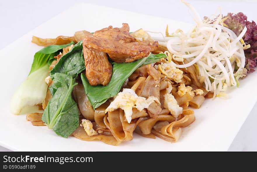 Asian stir fried flat rice noodles. Pad se ew with chicken.