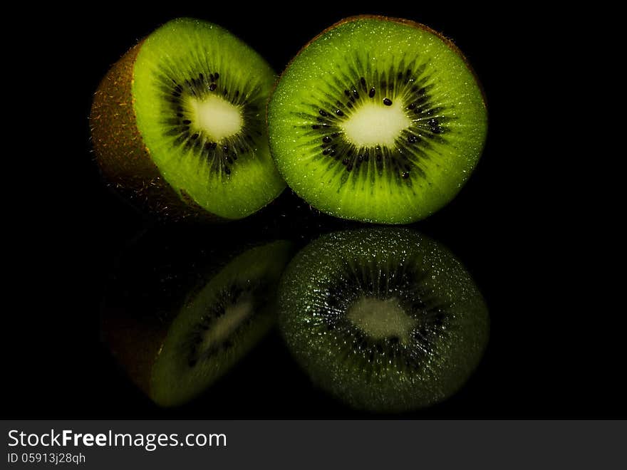 A fresh and juicy kiwi cut into halves and ready to be served. A fresh and juicy kiwi cut into halves and ready to be served.