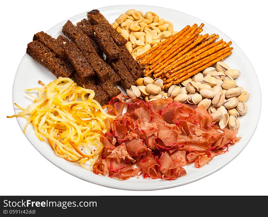 Plate full of crunchy, salty snacks, peanuts, pistachio nut cheese and meat. Plate full of crunchy, salty snacks, peanuts, pistachio nut cheese and meat