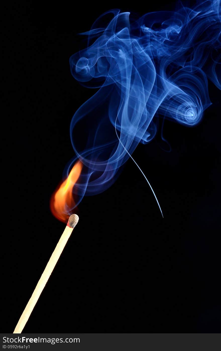 The burning match in the black background