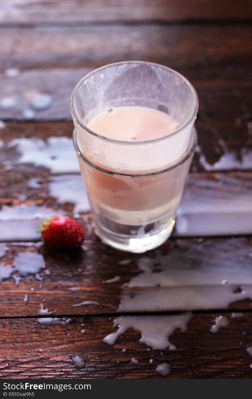 A splash of strawberry milk in glass